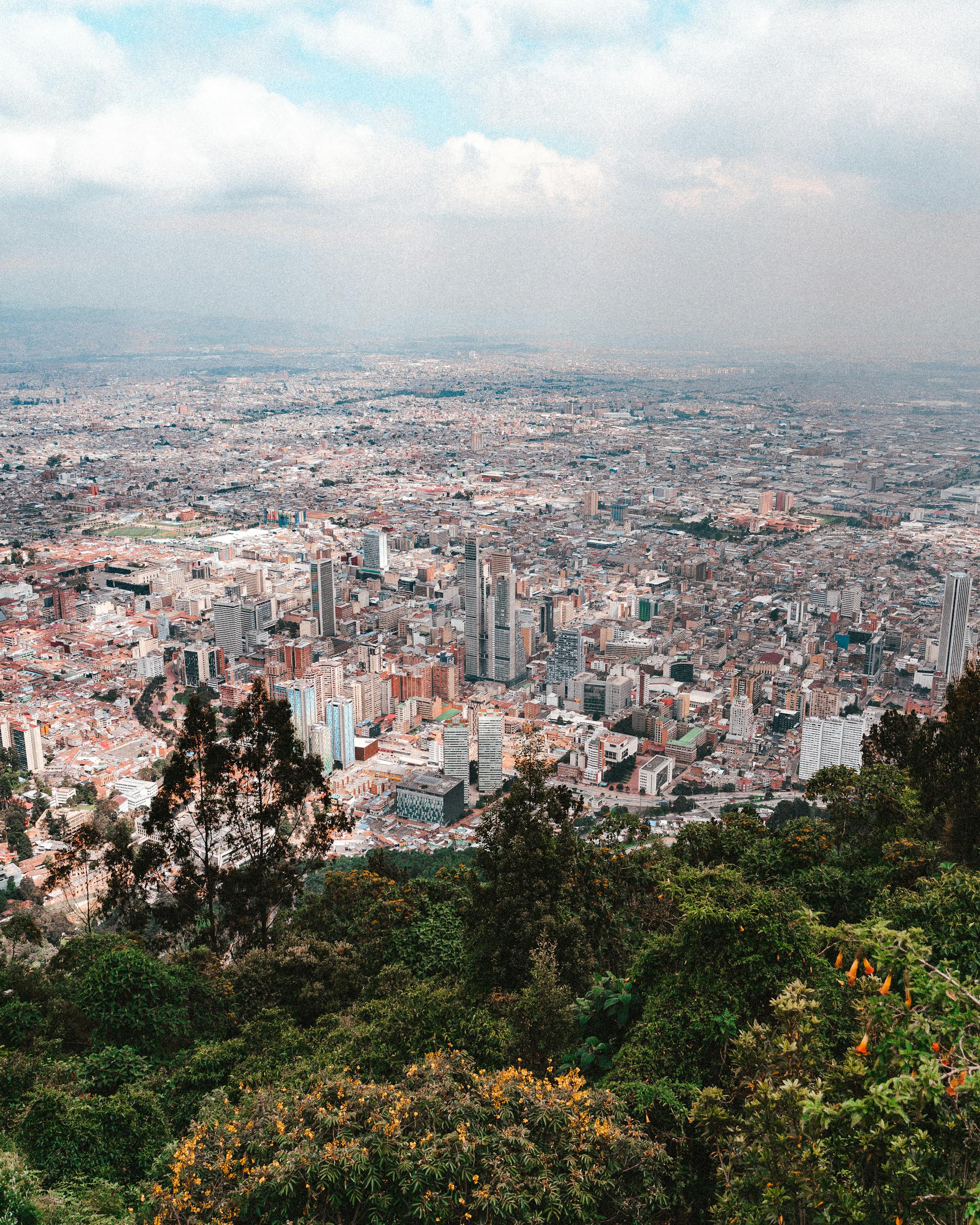 Stunning aerial view of Bogotá, Colombia, showcasing its vibrant urban landscape and surrounding greenery.